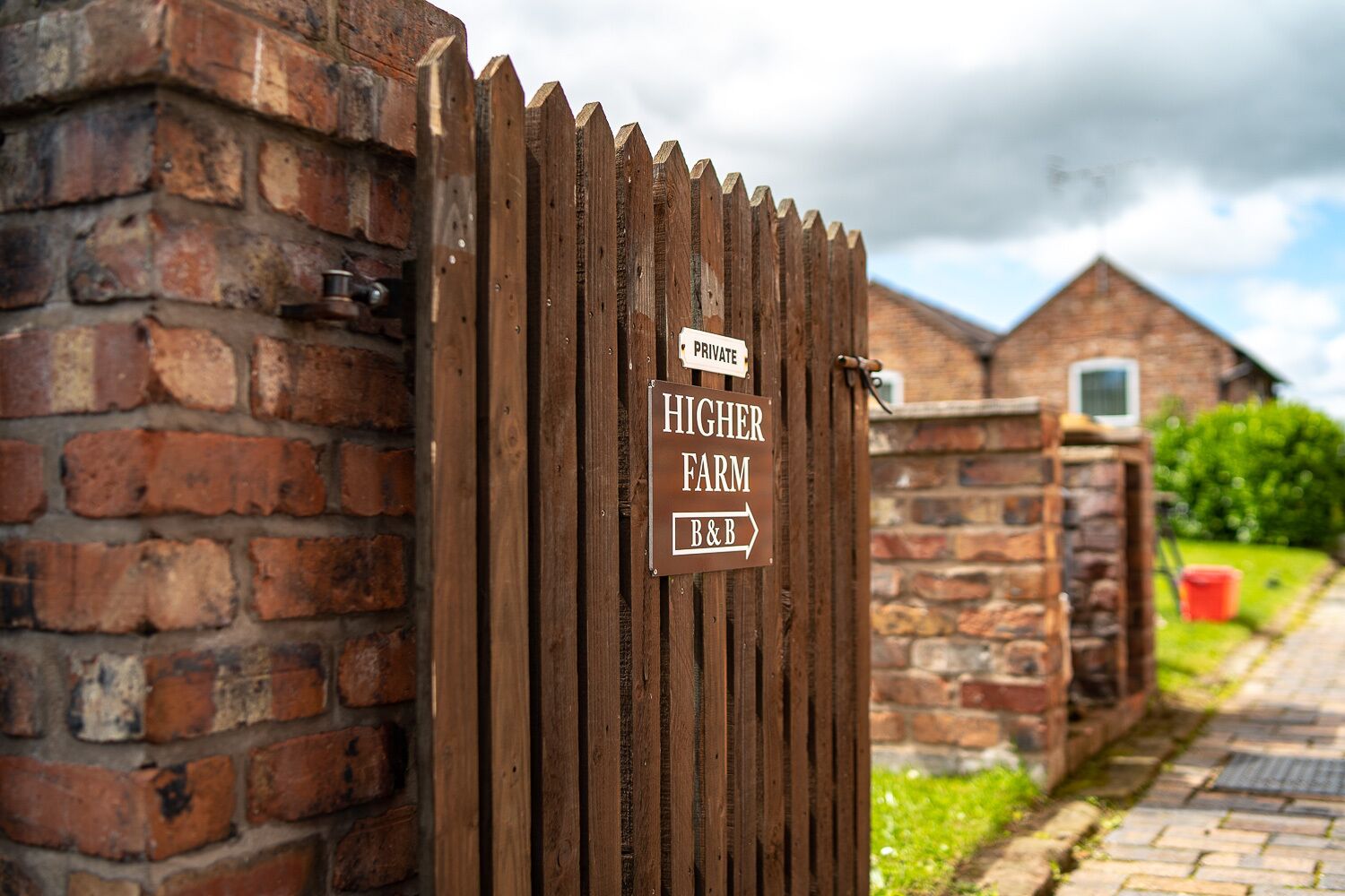 A wooden gate with a sign indicating a private farm and a B&B.