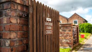 A wooden gate with a sign indicating a private farm and a B&B.