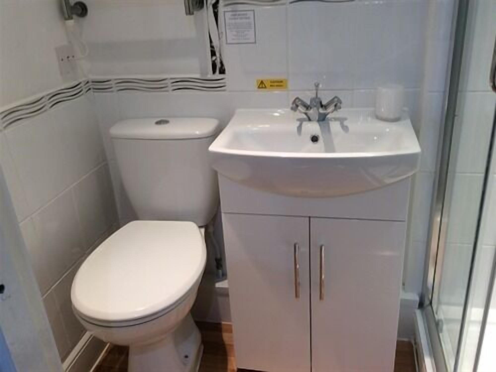 Un baño con inodoro, lavamanos y armario.