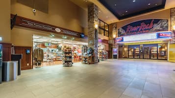 A spacious indoor area with a newsstand, a RiverRock Theatre sign, and a Box Office.