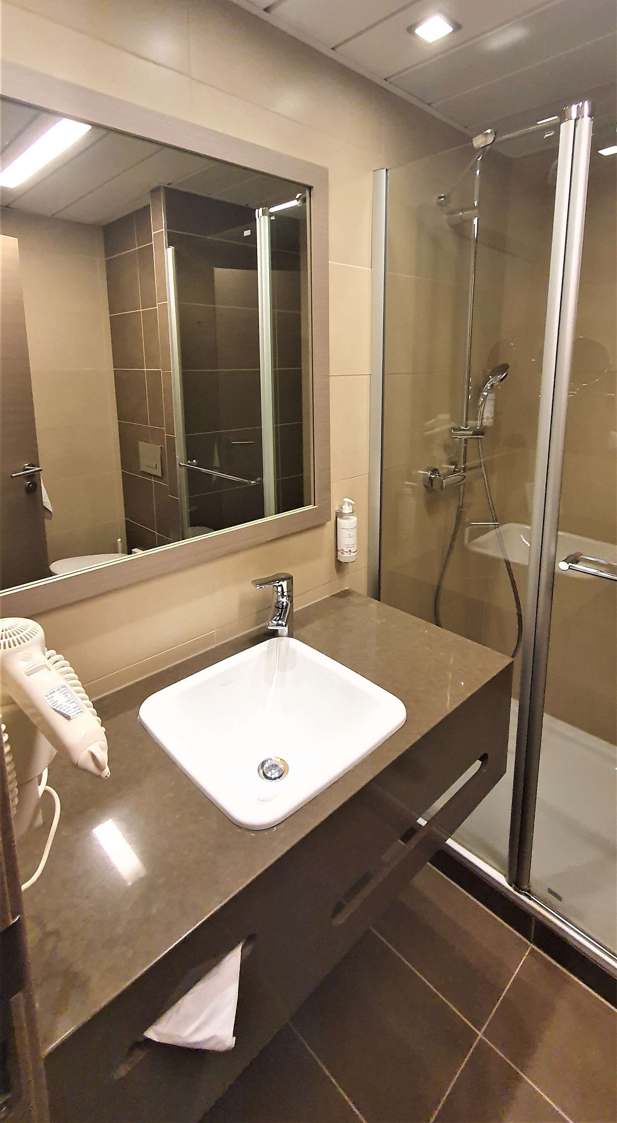 standard room, 1 king bed | bathroom | rainfall showerhead, eco-friendly toiletries, hair dryer, towels