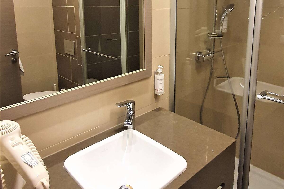 standard room, 1 king bed | bathroom | rainfall showerhead, eco-friendly toiletries, hair dryer, towels