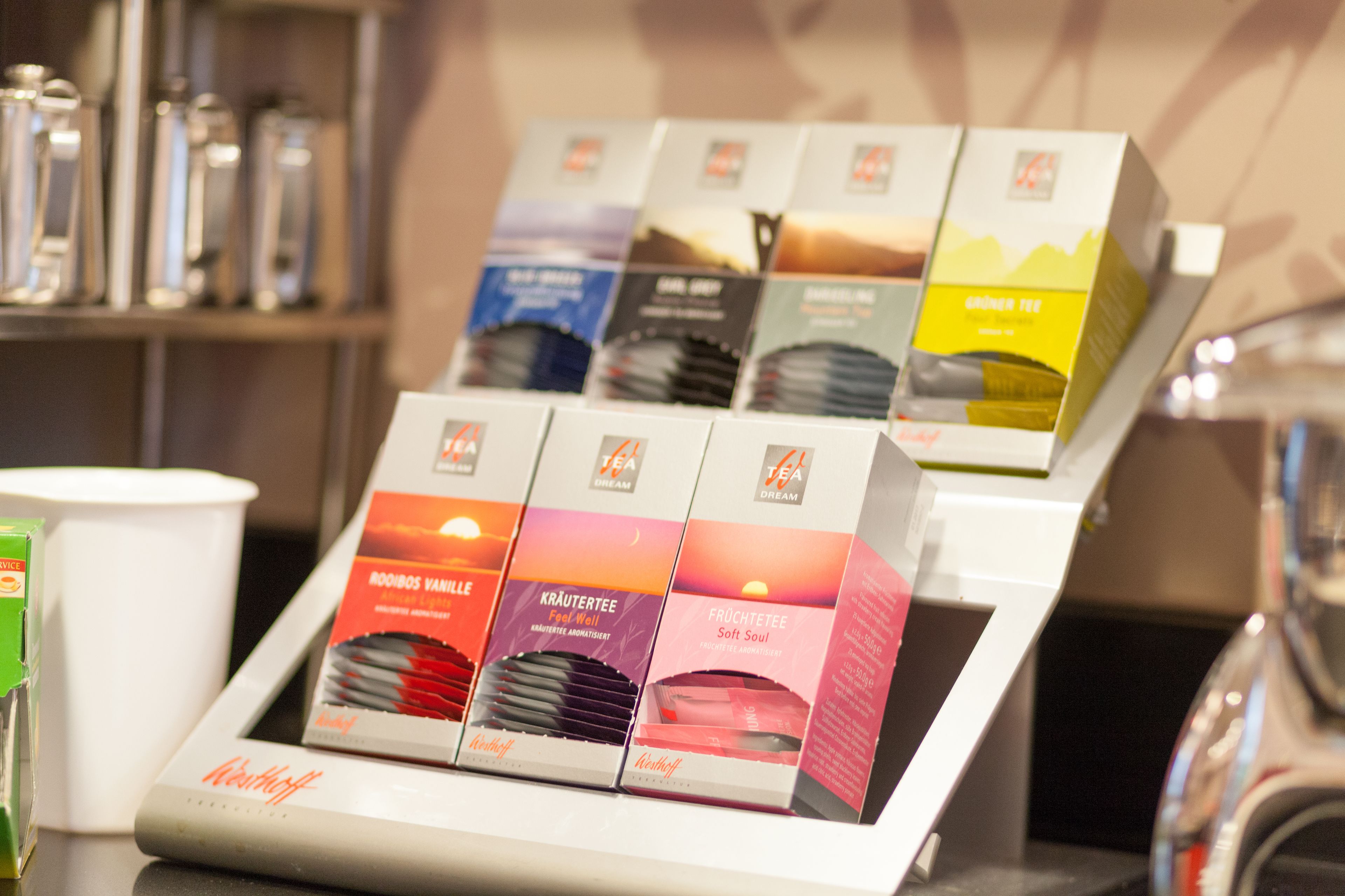 A display of tea boxes with various labels and designs.