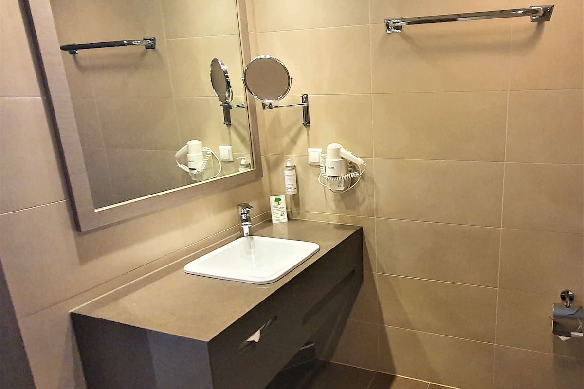 suite, 1 king bed | bathroom | rainfall showerhead, eco-friendly toiletries, hair dryer, towels