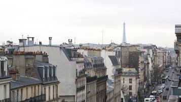 A cityscape with a prominent tower in the distance, likely a landmark.