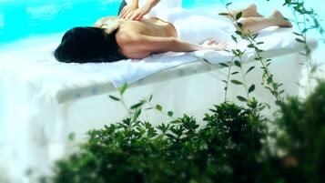 Relax by the serene pool surrounded by lush greenery, where spa services and leisure activities await.