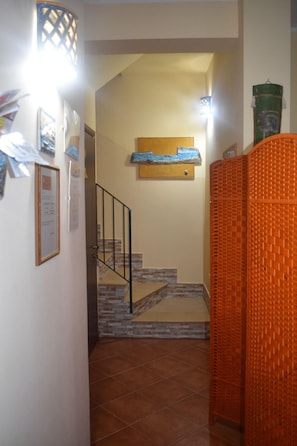 A staircase with a metal railing leading to a landing. - Magazzini San Domenico (Turin)