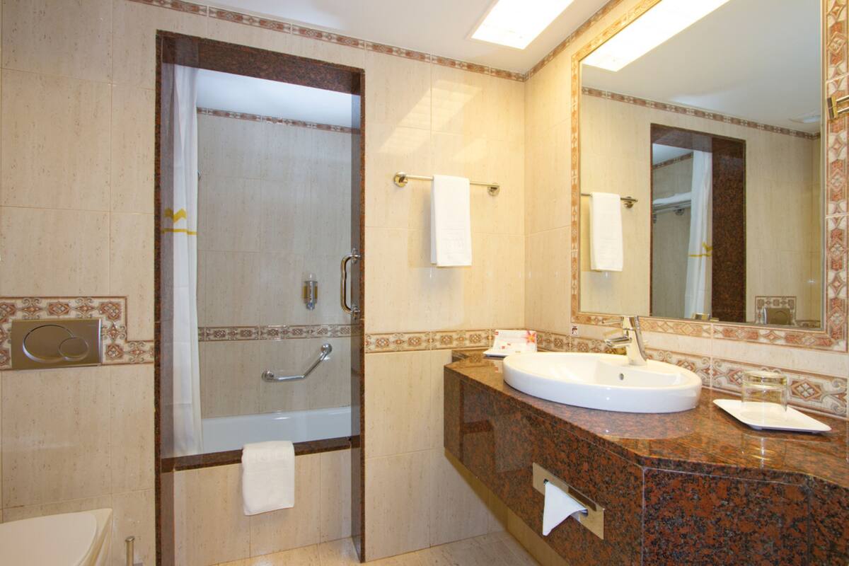 bathtub, eco-friendly toiletries, hair dryer, bathrobes