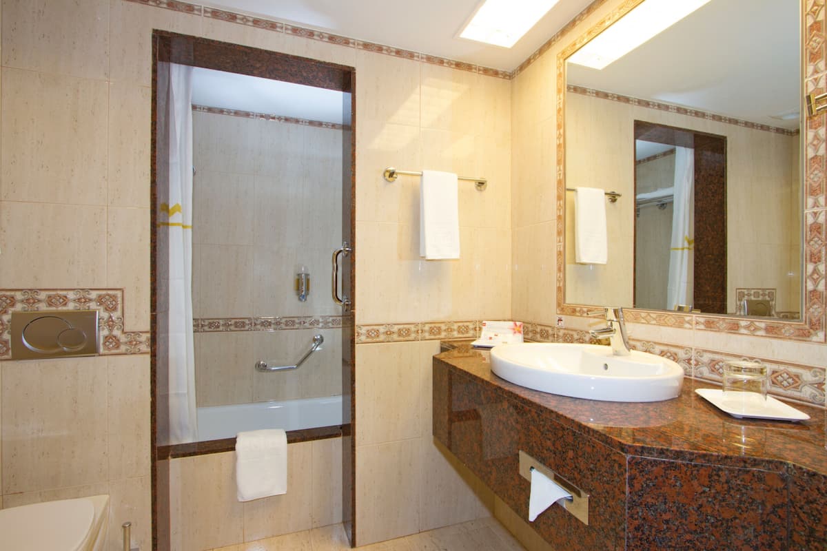 bathtub, eco-friendly toiletries, hair dryer, bathrobes