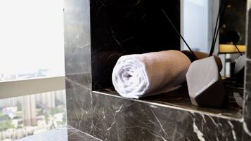 A towel on a marble surface near a window with a city view.