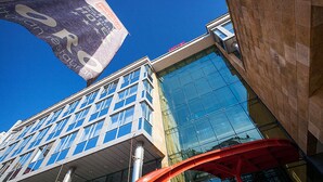 A modern building with large windows and a prominent glass facade.