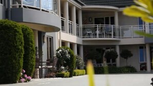 A multi-story building with a balcony on the second floor.
