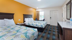 A hotel room with two beds, a desk, a chair, a bathroom, and a large mirror. - Cardinal Motel (Bowling Green)