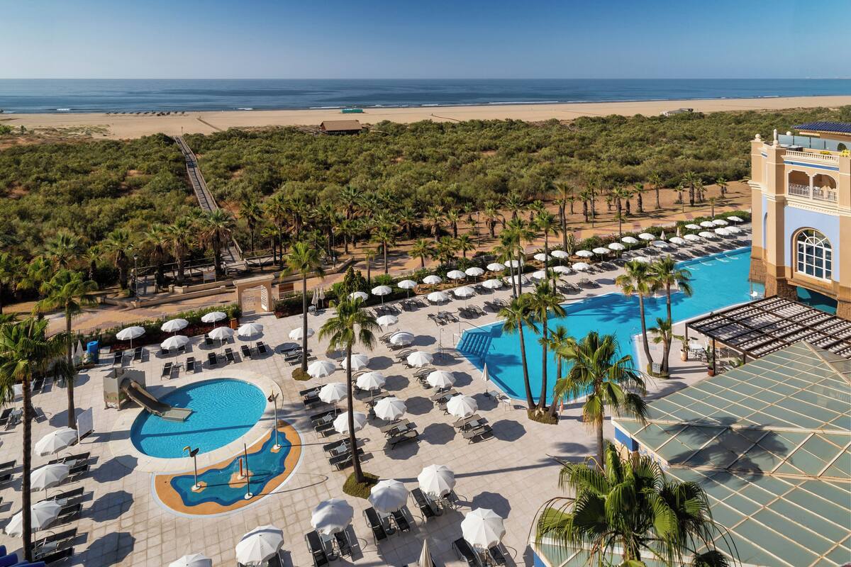 indoor pool, outdoor pool, pool umbrellas, pool loungers