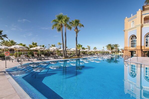 Indoor pool, outdoor pool, pool umbrellas, pool loungers