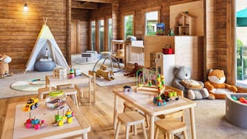Children's play area offers a variety of play spaces, a play tent, and educational materials.