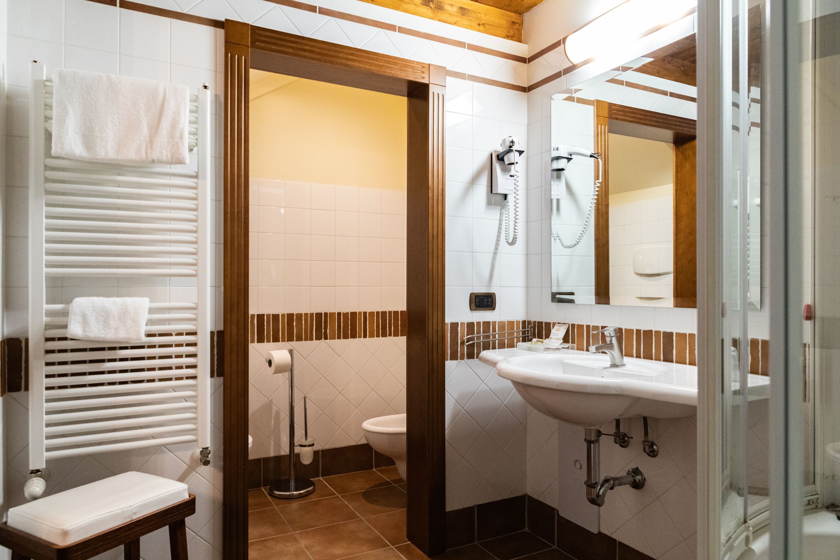 designer toiletries, hair dryer, bidet, towels