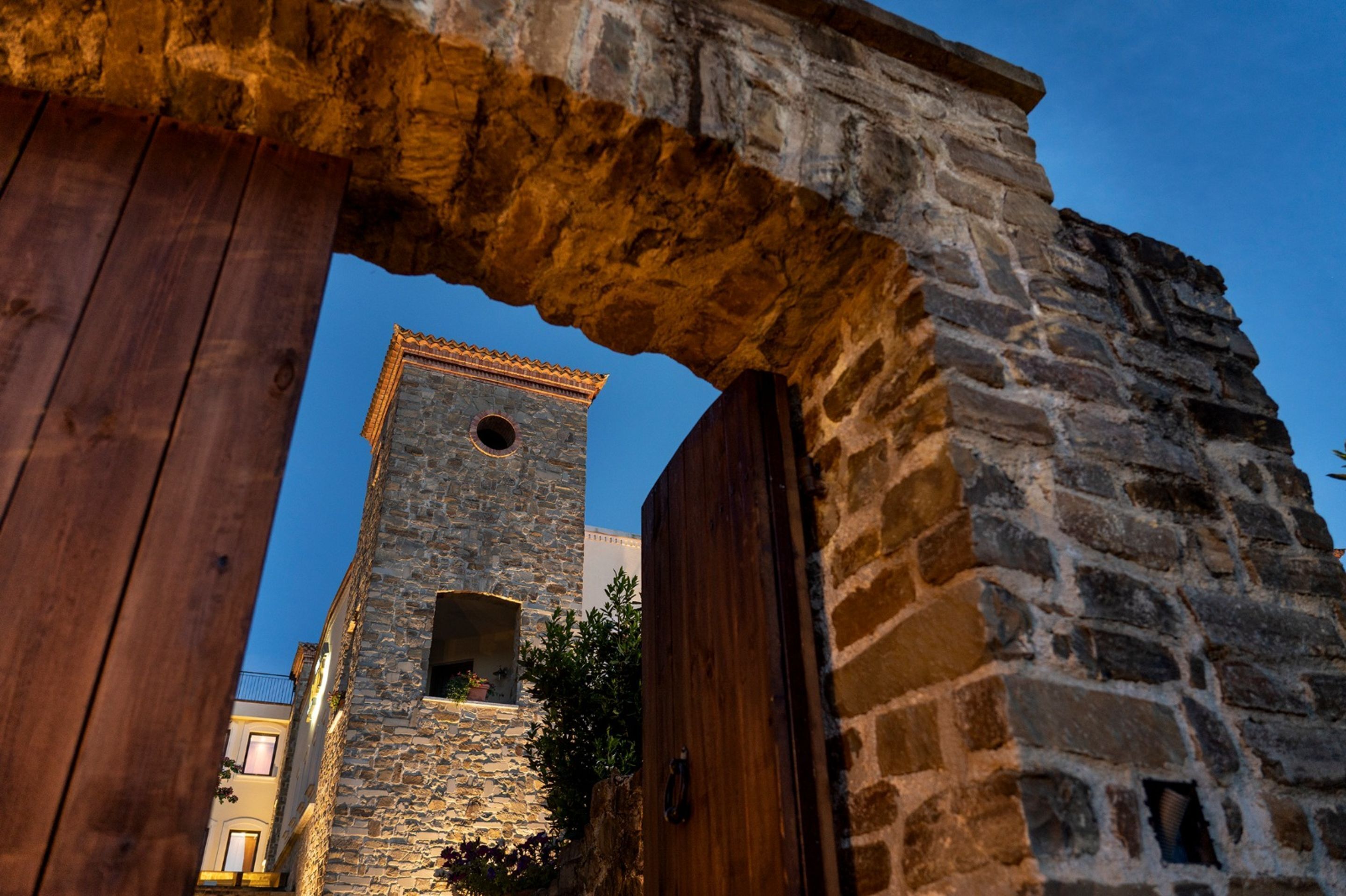 A stone building with a wooden door and a window.