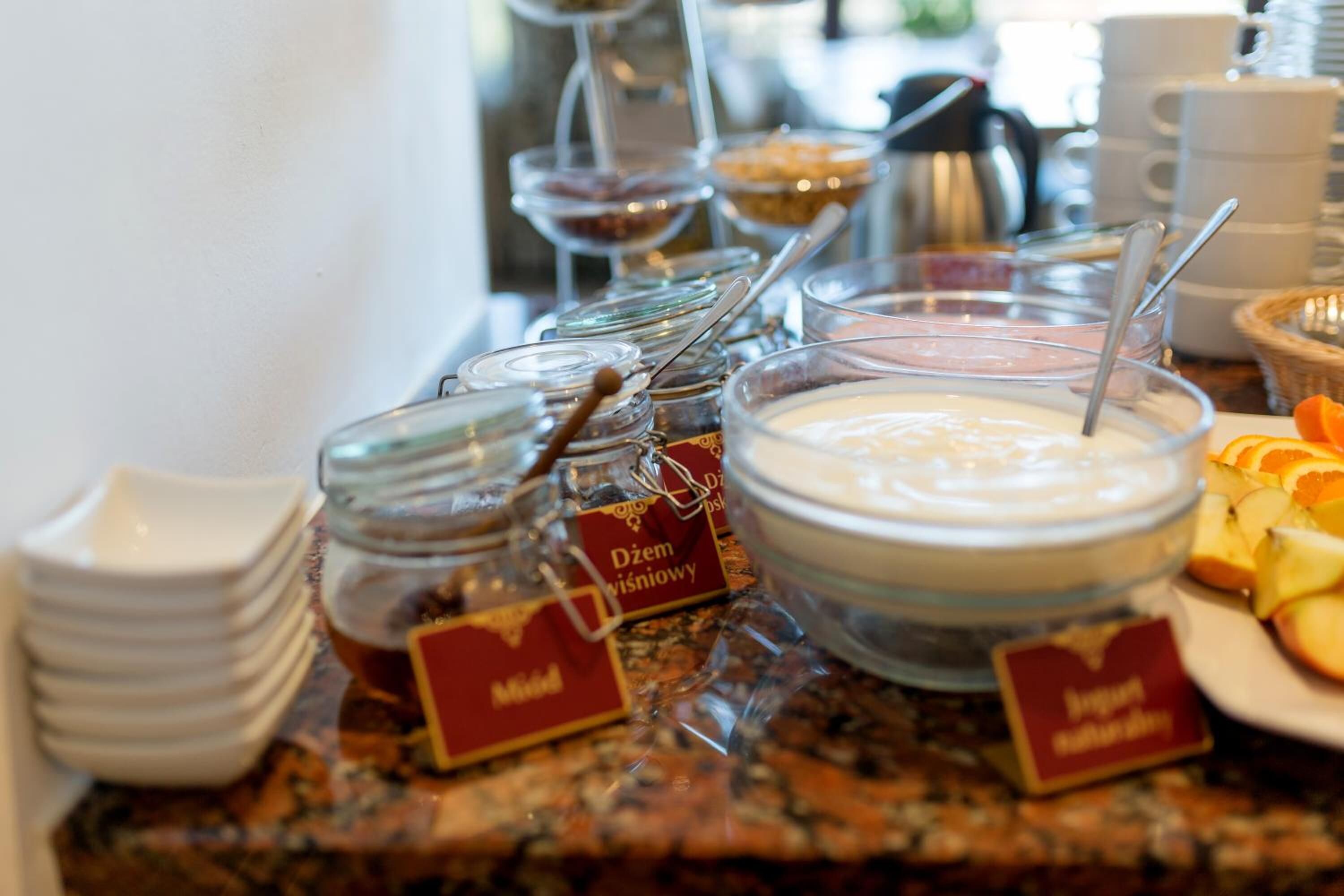 A buffet with various food items and containers labeled in a foreign language.