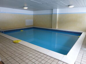 A rectangular indoor swimming pool with tiled walls and ceiling, a visible ceiling vent, and a tiled floor. - San Giusto (Falcade)