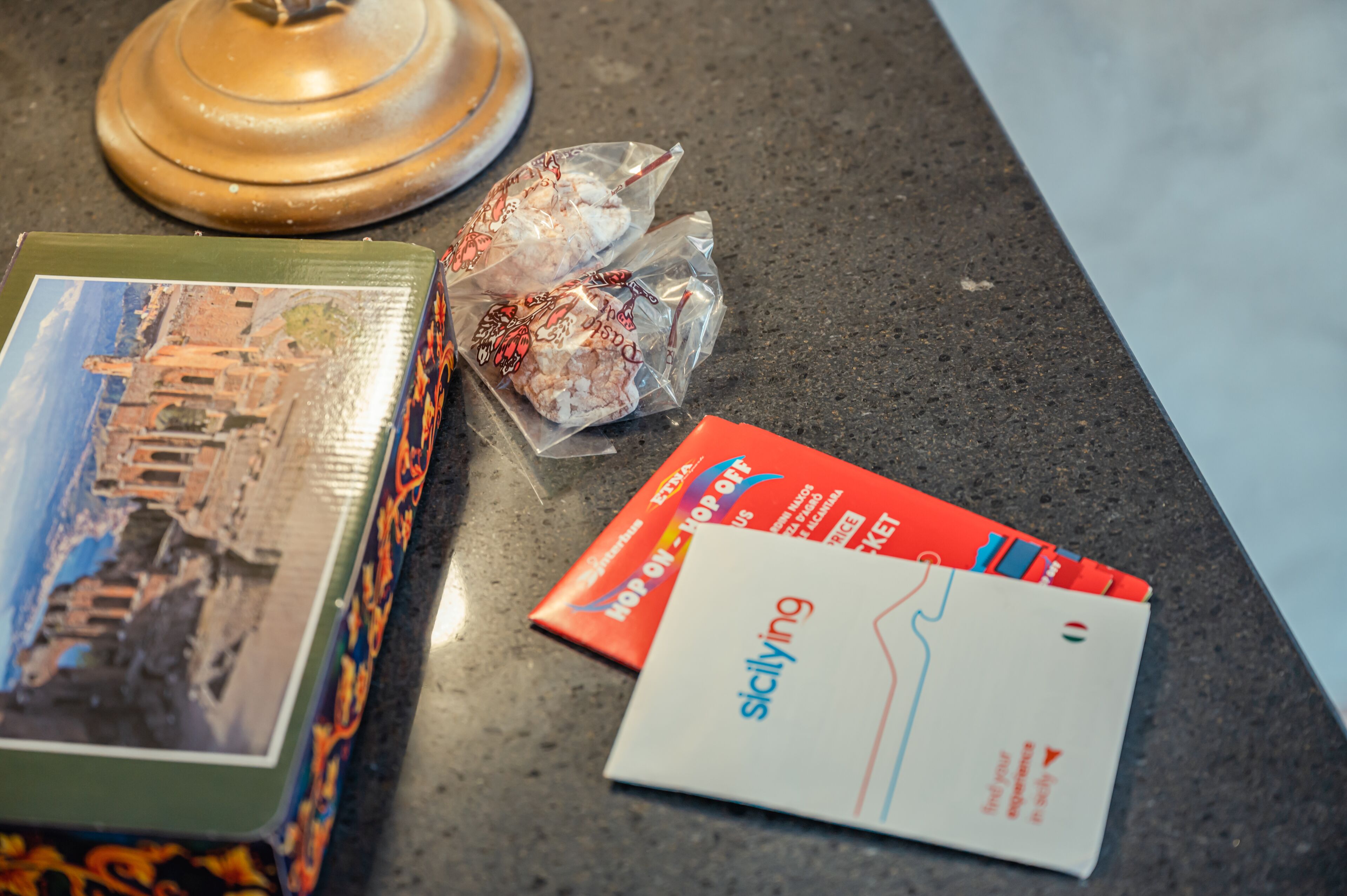 A table with a book, a map, and some travel brochures.