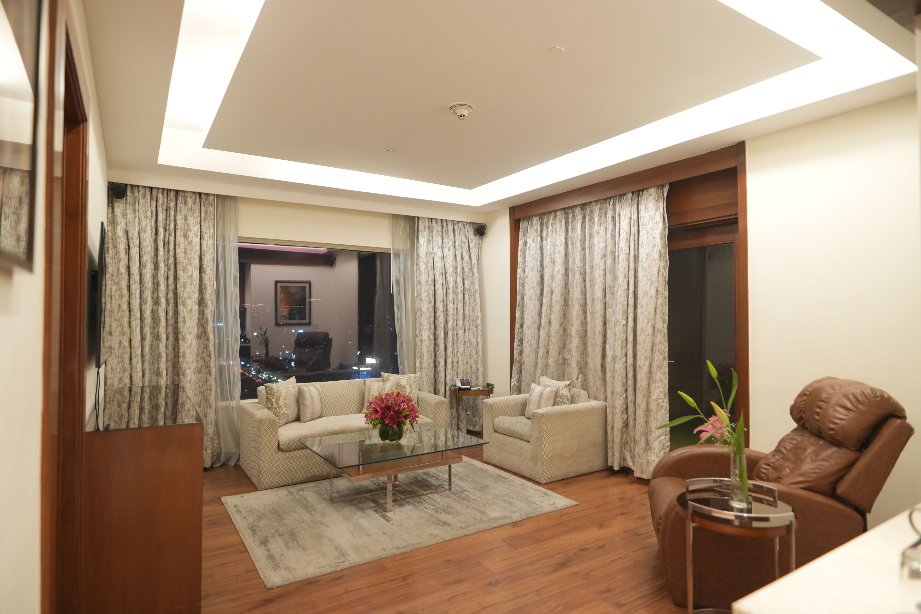 A modern living room with a sofa, armchair, and coffee table.