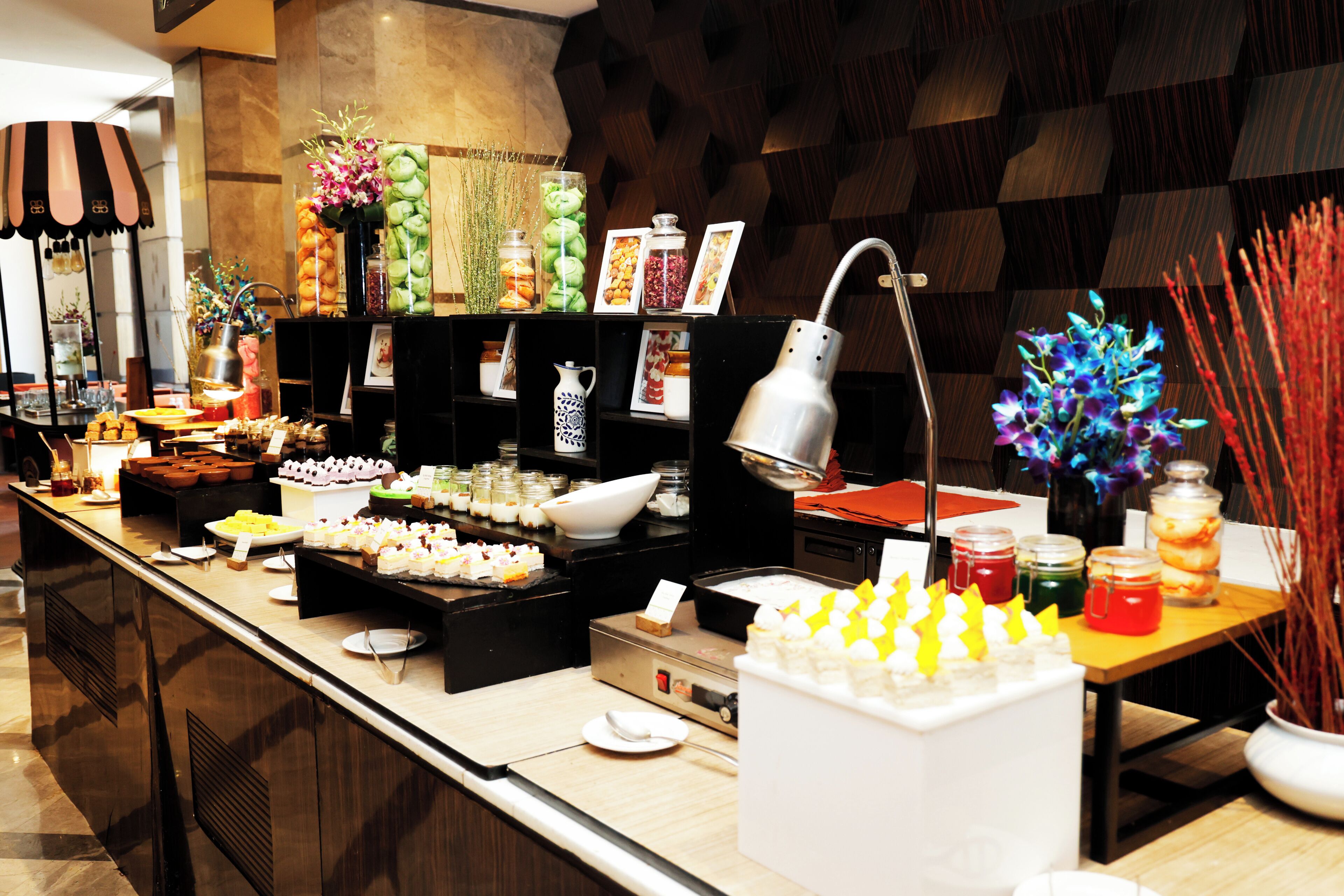 A buffet setup with various food items and condiments.