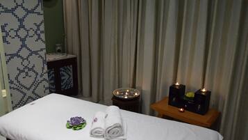 Relax in comfort with a neatly made bed, side table, and calming decor.