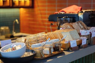 A breakfast buffet with various food items and condiments.