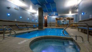 An indoor swimming pool with clear lanes, a hot tub, and seating areas. - Holiday Inn Hotel & Suites Saskatoon Downtown by IHG (Saskatoon)