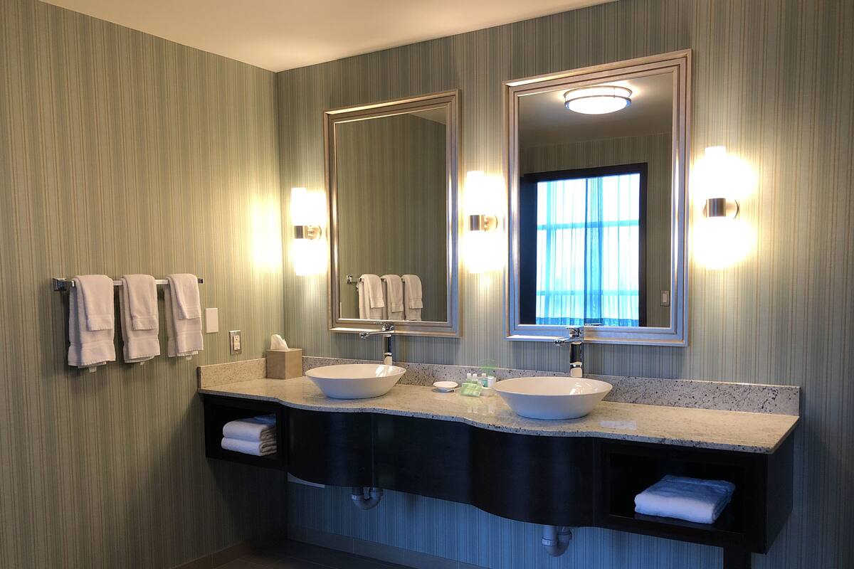 combined shower/bathtub, designer toiletries, hair dryer, towels