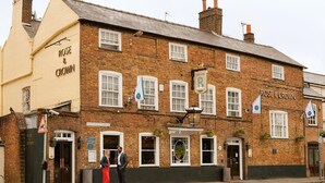 A traditional brick building with the name "Rose & Crown" on the facade, featuring multiple windows, a signboard, and a street name sign "High Street". - The Rose & Crown Wimbledon (London)
