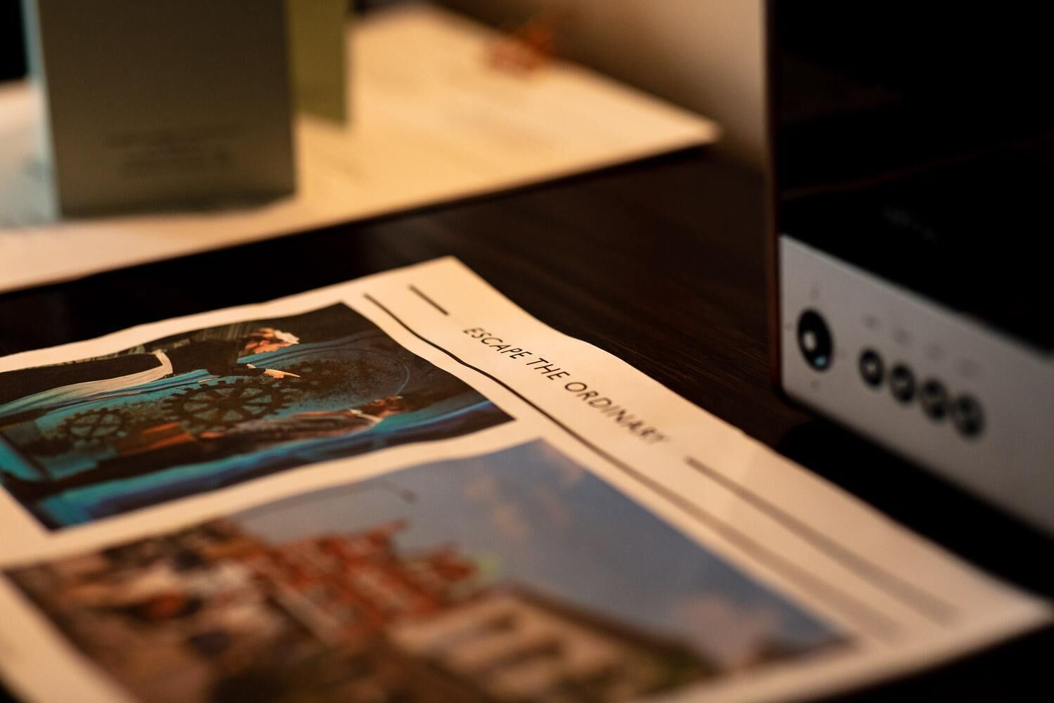 A brochure with a cityscape and a gear-like structure.
