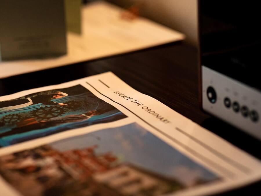 A brochure with a cityscape and a gear-like structure.