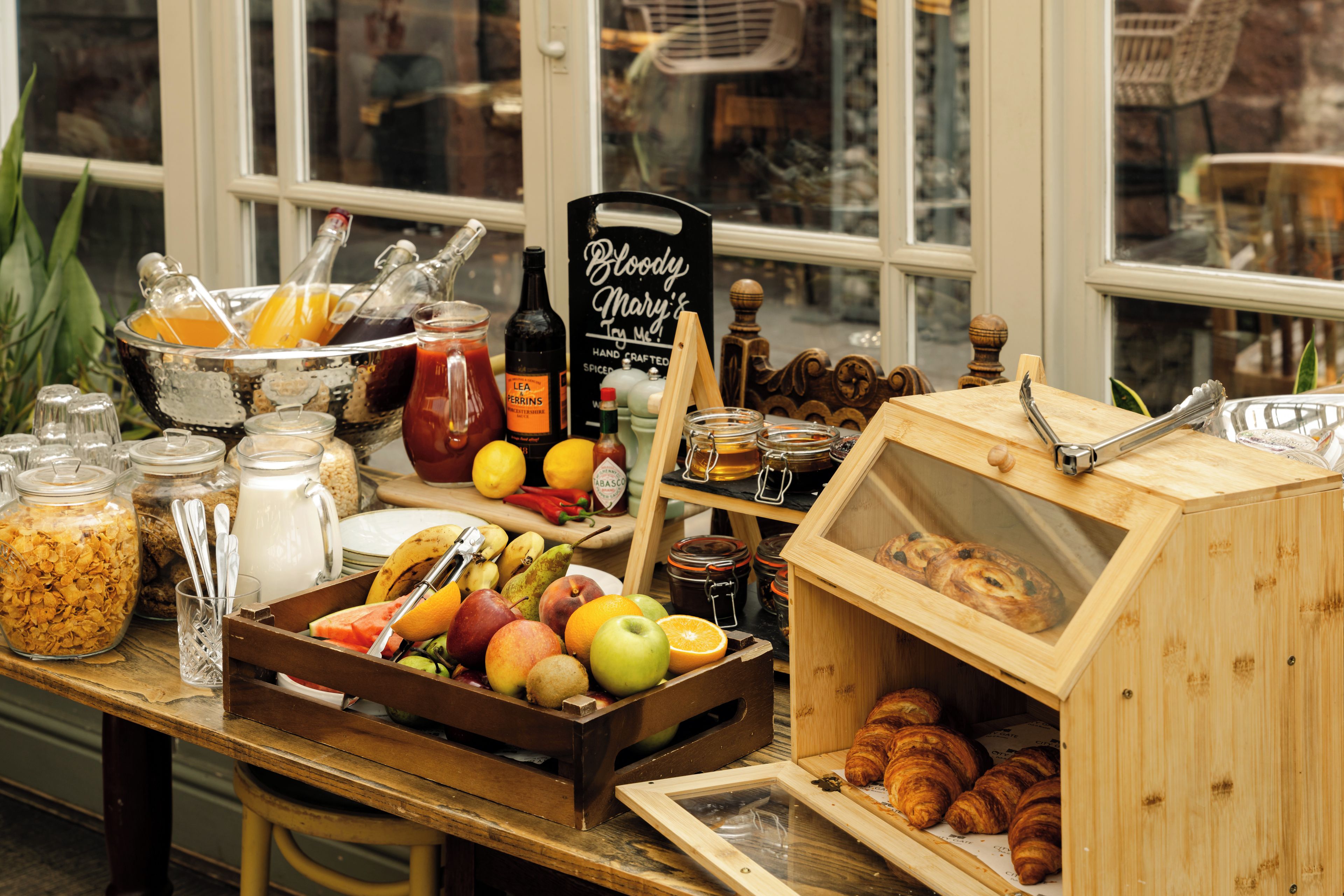 A breakfast buffet with various food items and condiments.