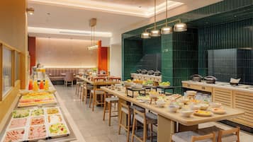A buffet setup with various food items and seating arrangements.