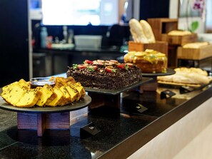 A dessert display with various cakes and pastries on a counter. - ibis Sao Luis (São Luís)