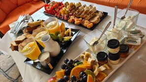 A breakfast buffet with various fruits, pastries, and spreads. - Hotel Petunia (Sithonia)