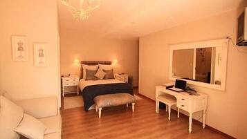 A bedroom with a bed, bedside tables, a desk, a chair, and a mirror.