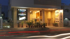 A hotel with a modern design, featuring a large illuminated sign for 'Coraltree by Goldfinch' and 'Coraltree by Kwlt'. - Coraltree By Goldfinch Hotels Bangalore (Bengaluru)