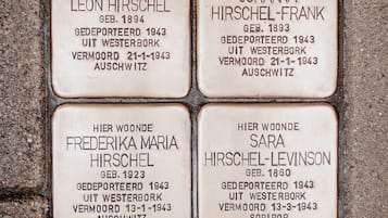Four memorial plaques on a wall.