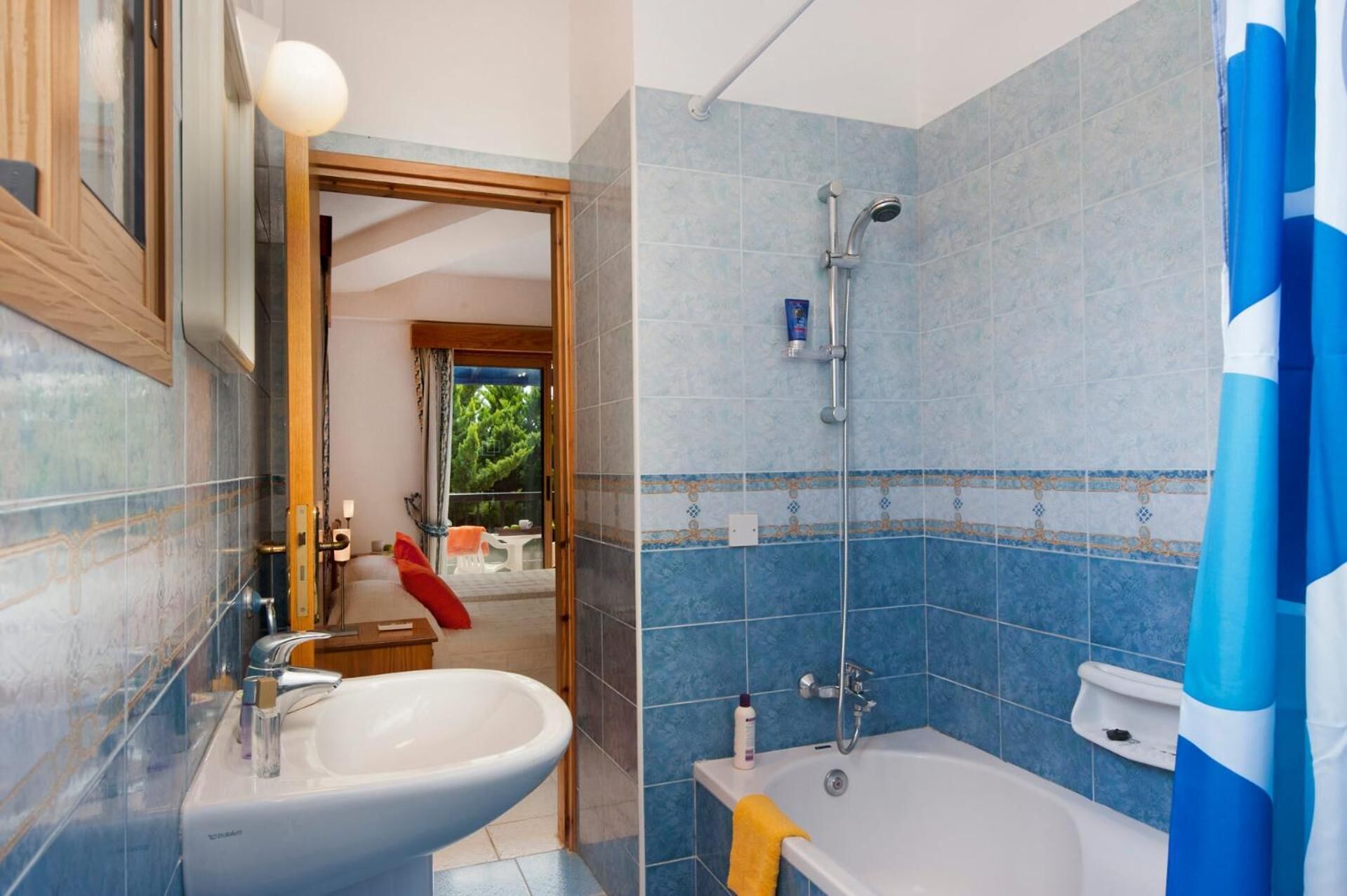 A bathroom with a sink, bathtub, and shower.