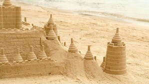 A beach with a sandcastle and overwater bungalows. - Batam View Beach Resort (Batam)