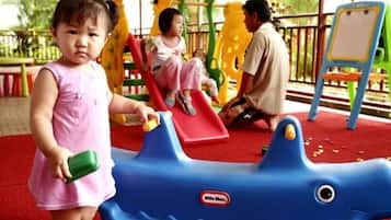 Children can play and explore in this family-friendly play area featuring a shark-shaped toy and a slide.
