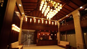 A spacious lobby with a reception desk, seating area, and a large chandelier. - Golden Phoenix Hotel Boracay (Boracay Island)