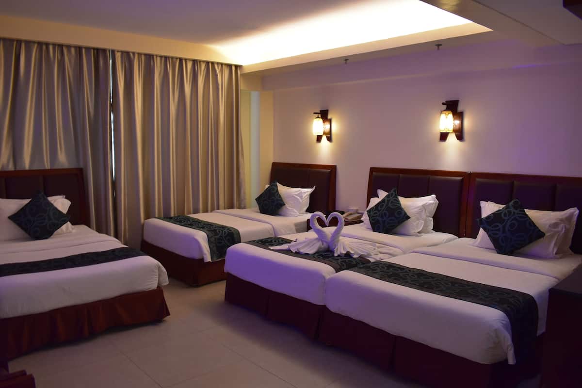 Quad Family Room | Minibar, in-room safe, individually furnished, desk