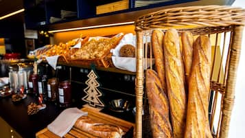 A bakery display with various breads and pastries.