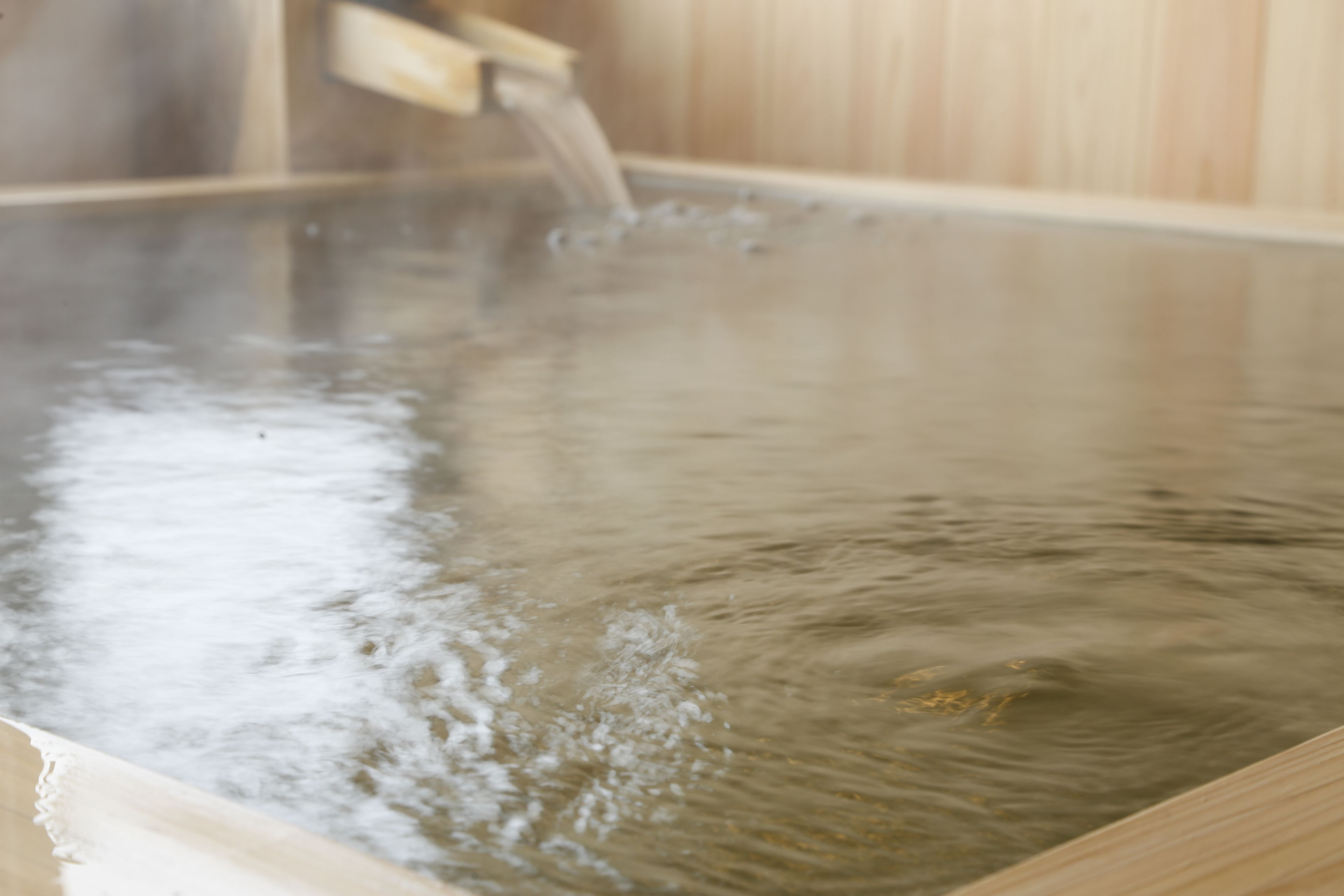 A hot spring bath with water flowing into it.