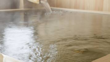 A hot spring bath with water flowing into it.