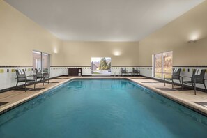 An indoor swimming pool with chairs and a view of the outside. - Fairfield Inn & Suites Marietta (Marietta)